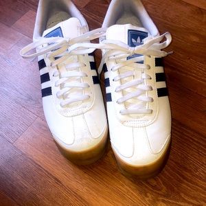 White Adidas shoes with blue strip